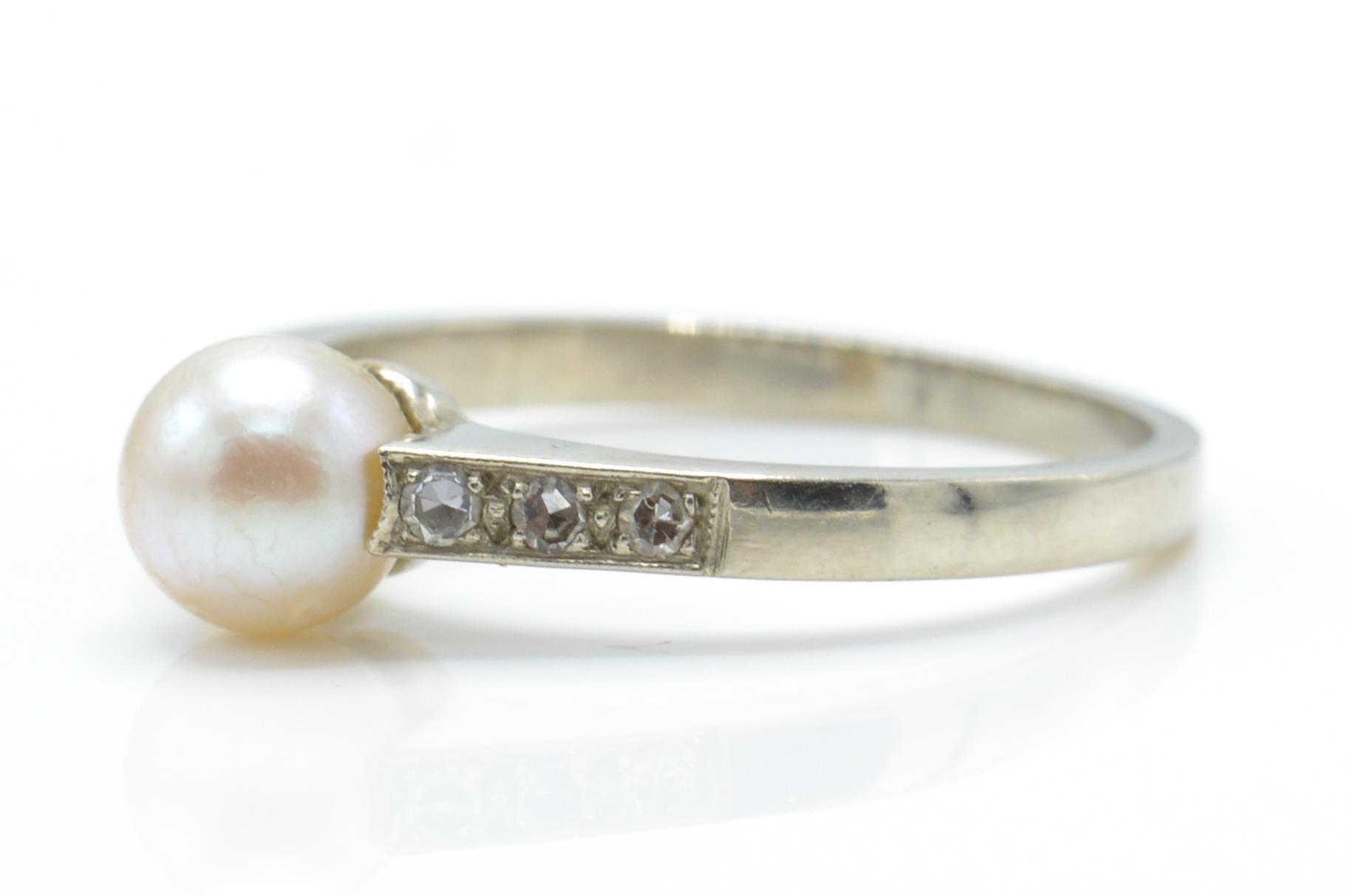 A 9ct white gold, pearl and diamond ring. The ring set with a central pearl - Image 2 of 3