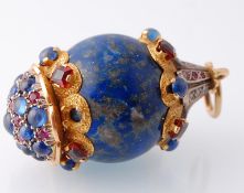 A large gold and silver mounted lapis lazuli diamond sapphire and ruby pendant