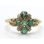 An antique 18ct hallmarked emerald and diamond ring. The ring set with 5 emeralds and rose cut