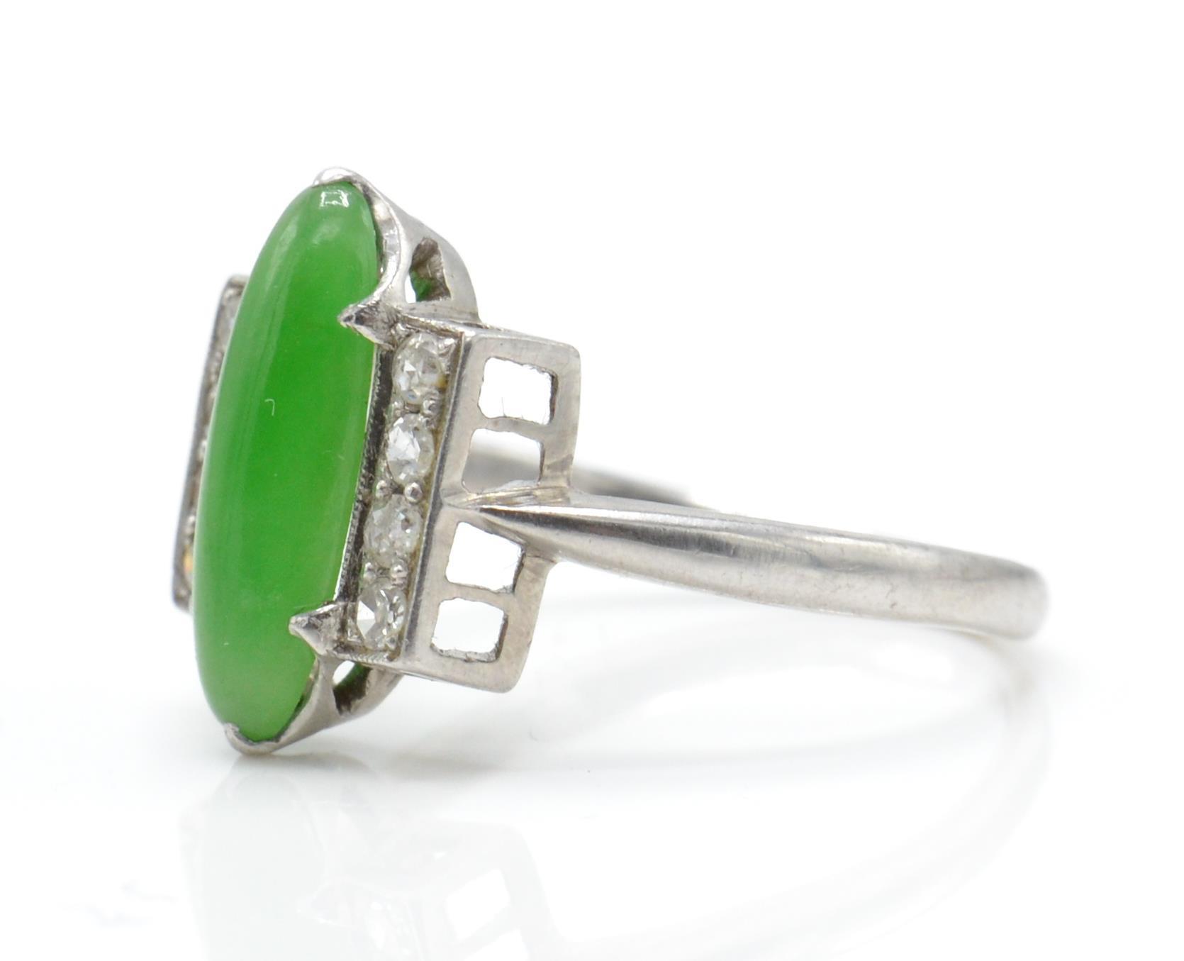 An Art Deco platinum, diamond and nephrite ring. The ring set with a green cabochon possible - Image 2 of 3