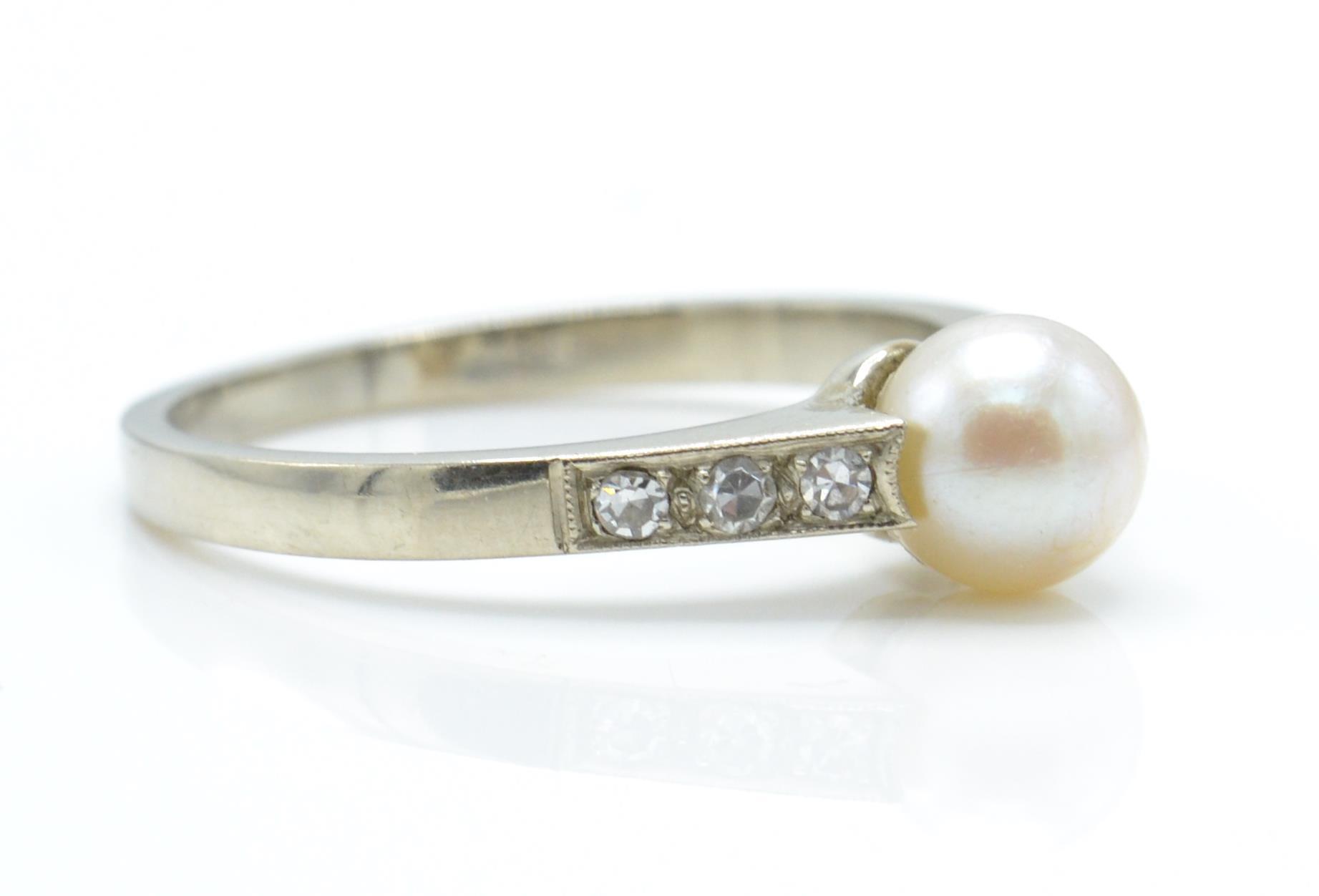 A 9ct white gold, pearl and diamond ring. The ring set with a central pearl - Image 3 of 3