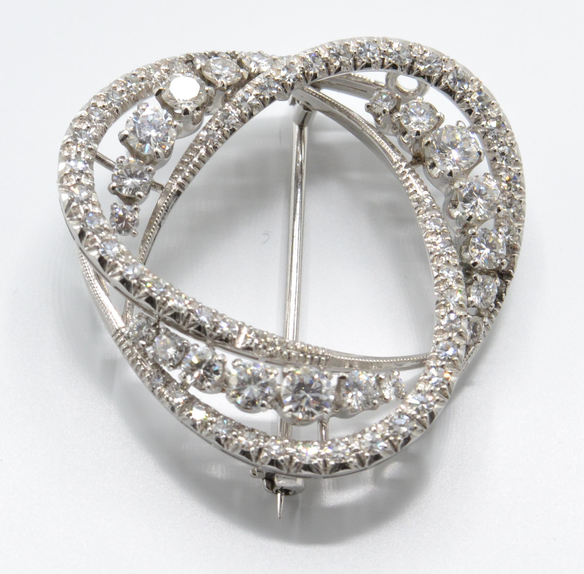 An 18ct white gold and diamond brooch pin. The brooch being set with elliptical arches