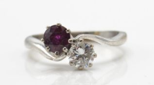 An 18ct white gold ruby and diamond cross over ring.