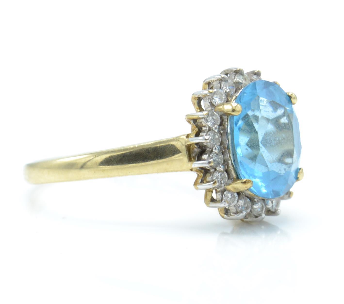 A hallmarked 9ct gold topaz and diamond cluster ring. The ring set with a central large oval mixed - Image 2 of 4