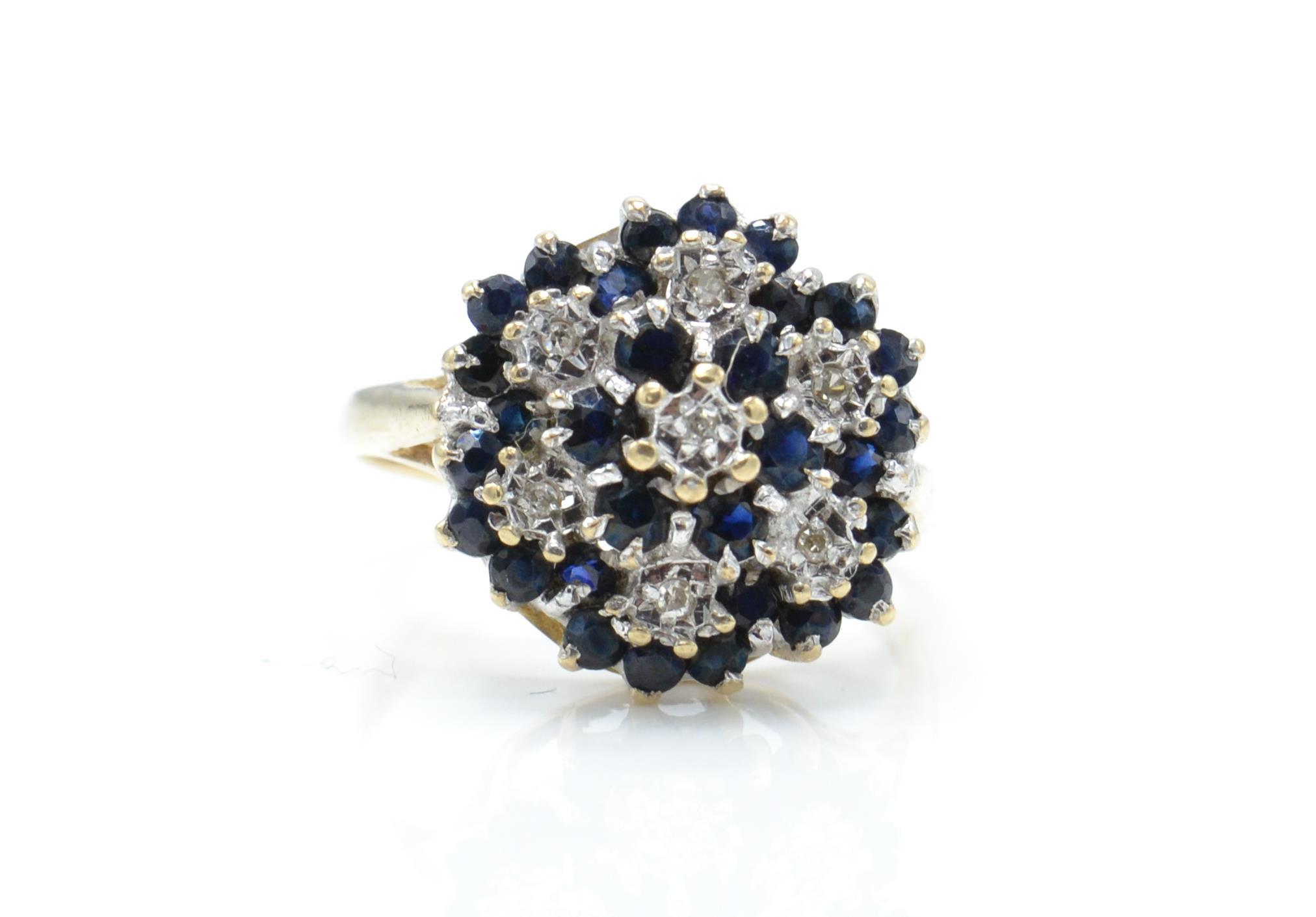 A hallmarked 9ct gold sapphire and diamond cluster ring.