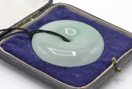A large Chinese Jade Bi roundel pendant. The pendant formed of a pierced roundel