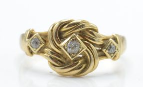 A hallmarked 18ct gold and diamond knot ring. The ring formed with a knot set with a central old cut
