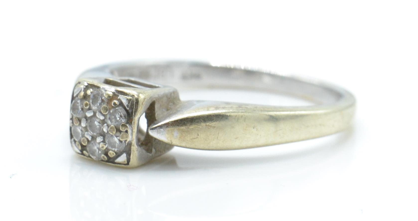 A hallmarked 9ct white gold and diamond ring. The ring having a cluster of diamonds within a - Image 2 of 5