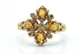 A hallmarked 18ct gold antique style diamond and yellow stone ring.