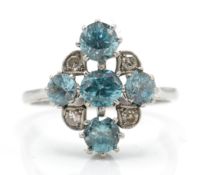A platinum zircon and diamond ring. The ring set with blue zircon in cruciform pierced setting