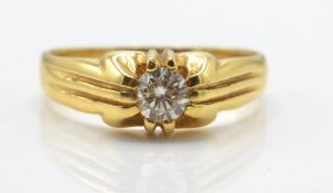 A gold and diamond solitaire ring. The ring set with a round brilliant cut diamond