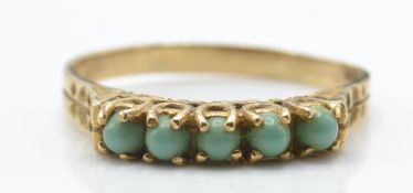 A 9ct gold London hallmarked gypsy ring. The ring with 5 prong mounted turquoise cabochons