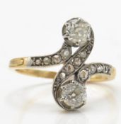 An early 20th century diamond crossover ring. The ring set 2 old cut diamonds