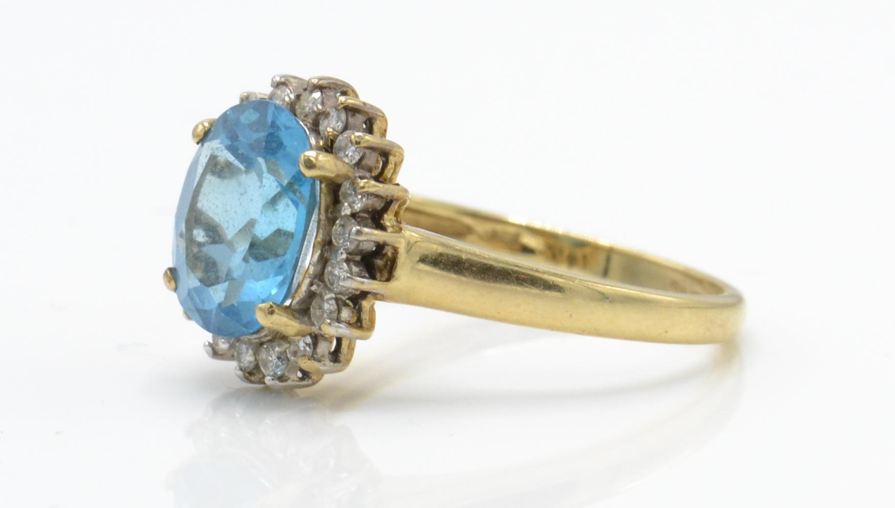 A hallmarked 9ct gold topaz and diamond cluster ring. The ring set with a central large oval mixed - Image 3 of 4