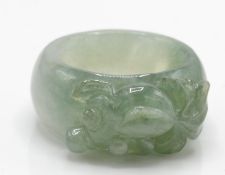 A Chinese carved hardstone Jade ring in the form of a fish.