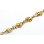 A French gold Art Nouveau seven link bracelet. The bracelet form of openwork links in the form of