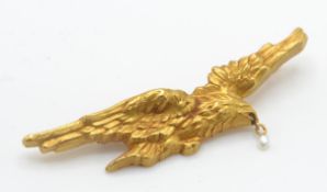 An Art Nouveau gold and pearl eagle bird brooch pin. The brooch in the form of an eagle