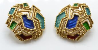 A pair of 18ct gold and enamel ear clips. The earrings having applied enamel decoration