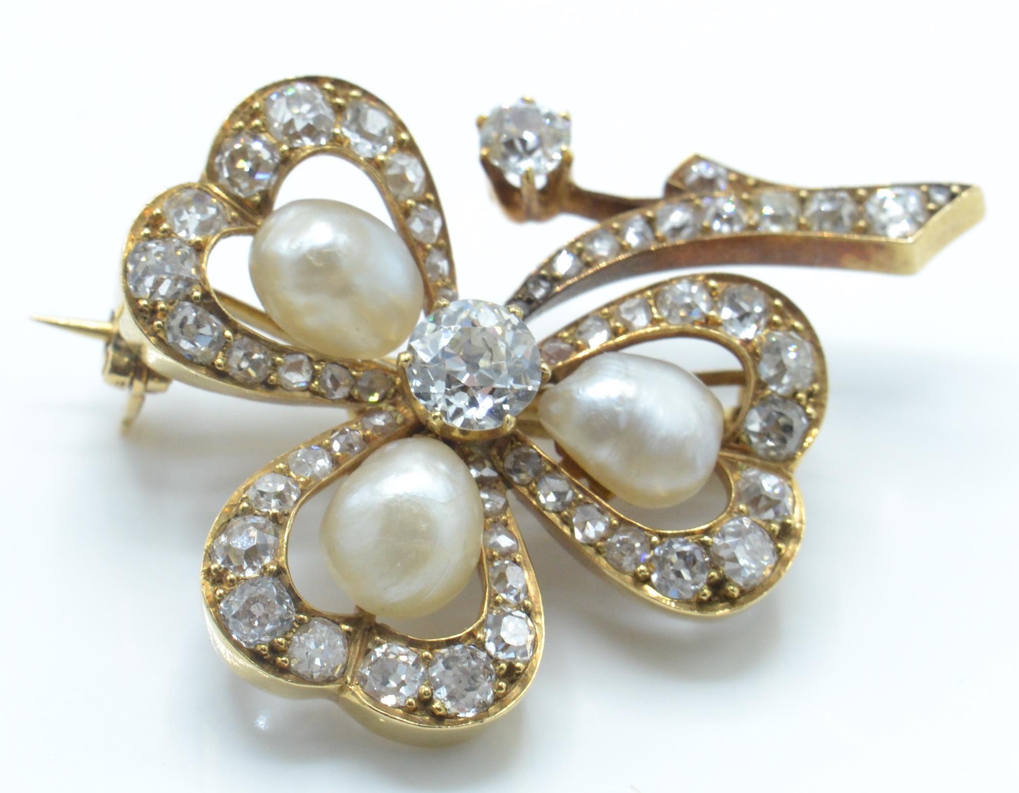 A gold pearl and diamond brooch pin. The brooch in the form of a shamrock