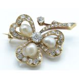 A gold pearl and diamond brooch pin. The brooch in the form of a shamrock