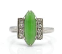 An Art Deco platinum, diamond and nephrite ring. The ring set with a green cabochon possible