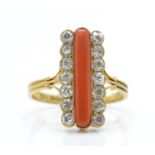 An 18ct gold 19th century coral and diamond ring. The ring having a central cabochon of coral