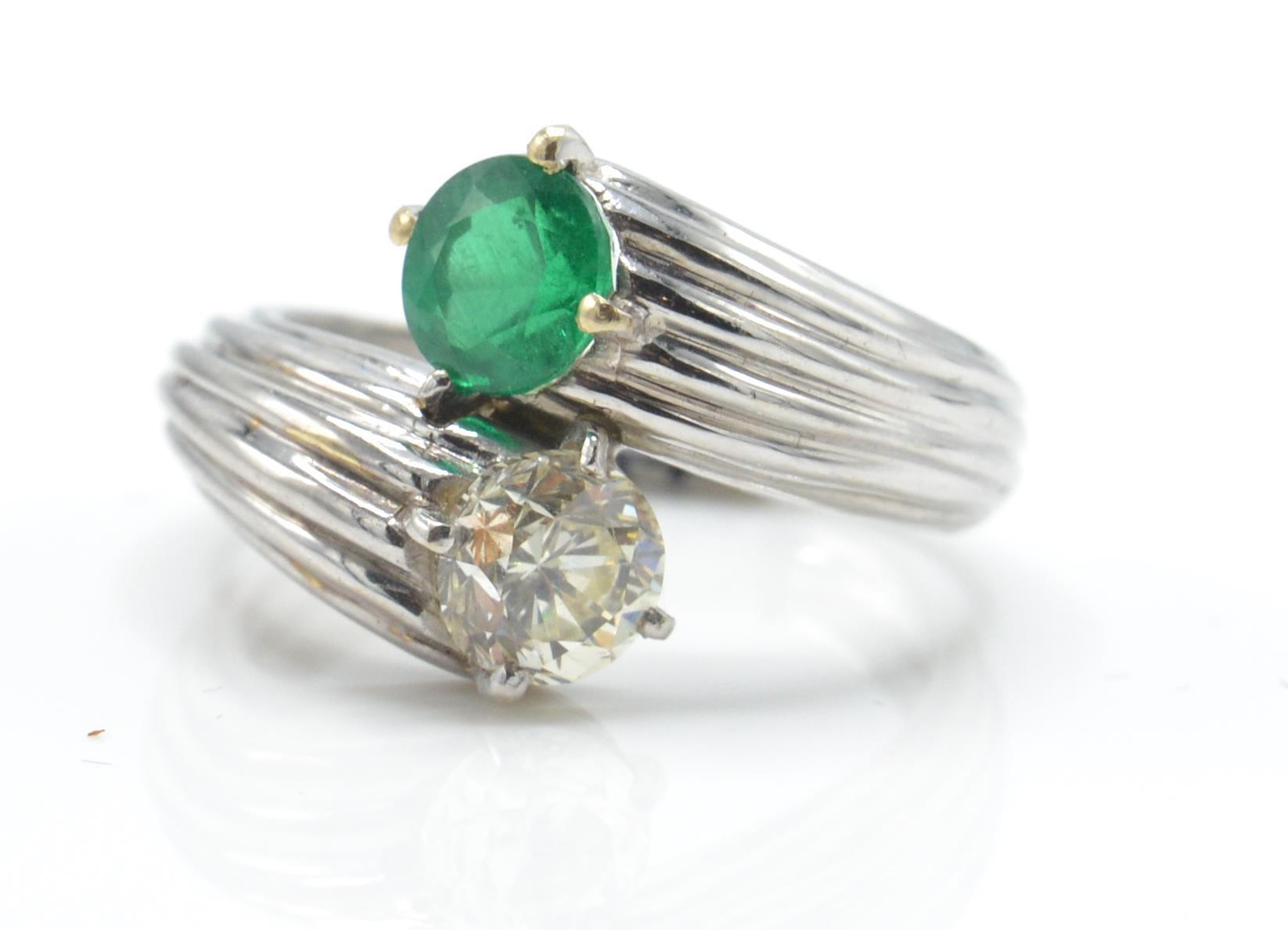 An emerald and diamond toi et moi ring. Estimated diamond weight 0.70cts - Image 2 of 6