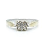 A hallmarked 9ct white gold and diamond ring. The ring having a cluster of diamonds within a