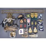 A collection of assorted military and Royal Navy uniform patches and accessories to include a