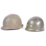 UNIFORMS AND FANCY DRESS - A PAIR OF METAL POST WWII AMERICAN COMBAT HELMETS.