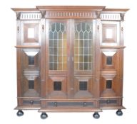 STUNNING 19TH CENTURY OAK AND EBONY BREAKFRONT BOOKCASE.