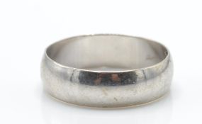 A 9ct white gold band ring. The band ring with Lon