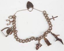 A silver charm bracelet having a heart padlock cla