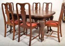 A 1920s mahogany extending dining table with cabri