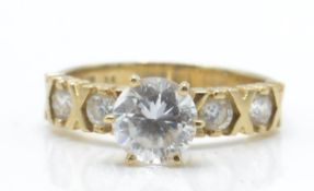 A 9ct gold and CZ solitaire ring. The ring with la