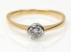 A stamped 750 18ct gold ring set with a round cut