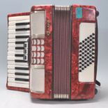 A vintage 20th Century red cased Galoh made accordion in good condition.