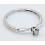 A stamped 375 white gold and diamond solitaire ring set with a single round cut diamond of