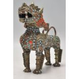 A 20th Century Chinese brass inkwell / brush pot in the form of in the form of a foo dog / temple