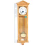 A 20th century Moon phase regulator wall clock with long case, brass weights and pendulum.  The