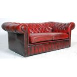 A 20th century Oxblood leather chesterfield button back sofa settee. The sofa with button backing to