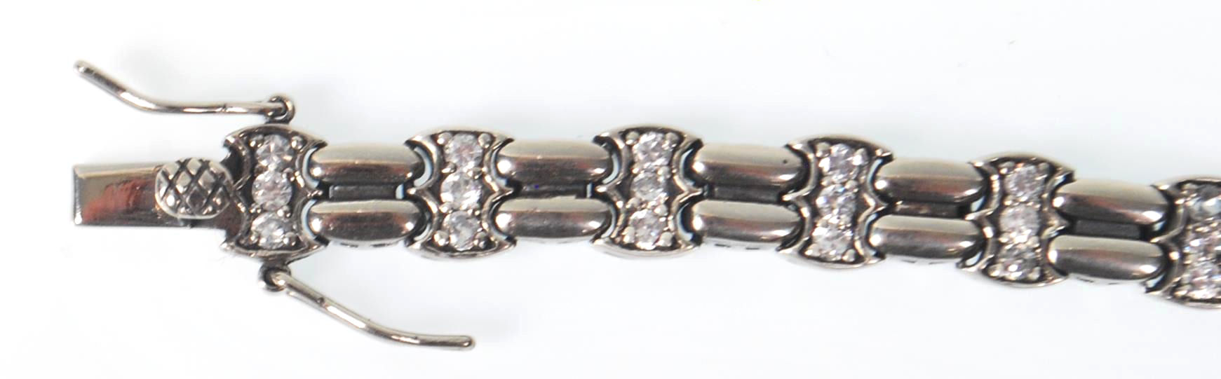 A ladies stamped 925 silver line bracelet being set with three round cut CZ stones with a tongue - Image 2 of 7