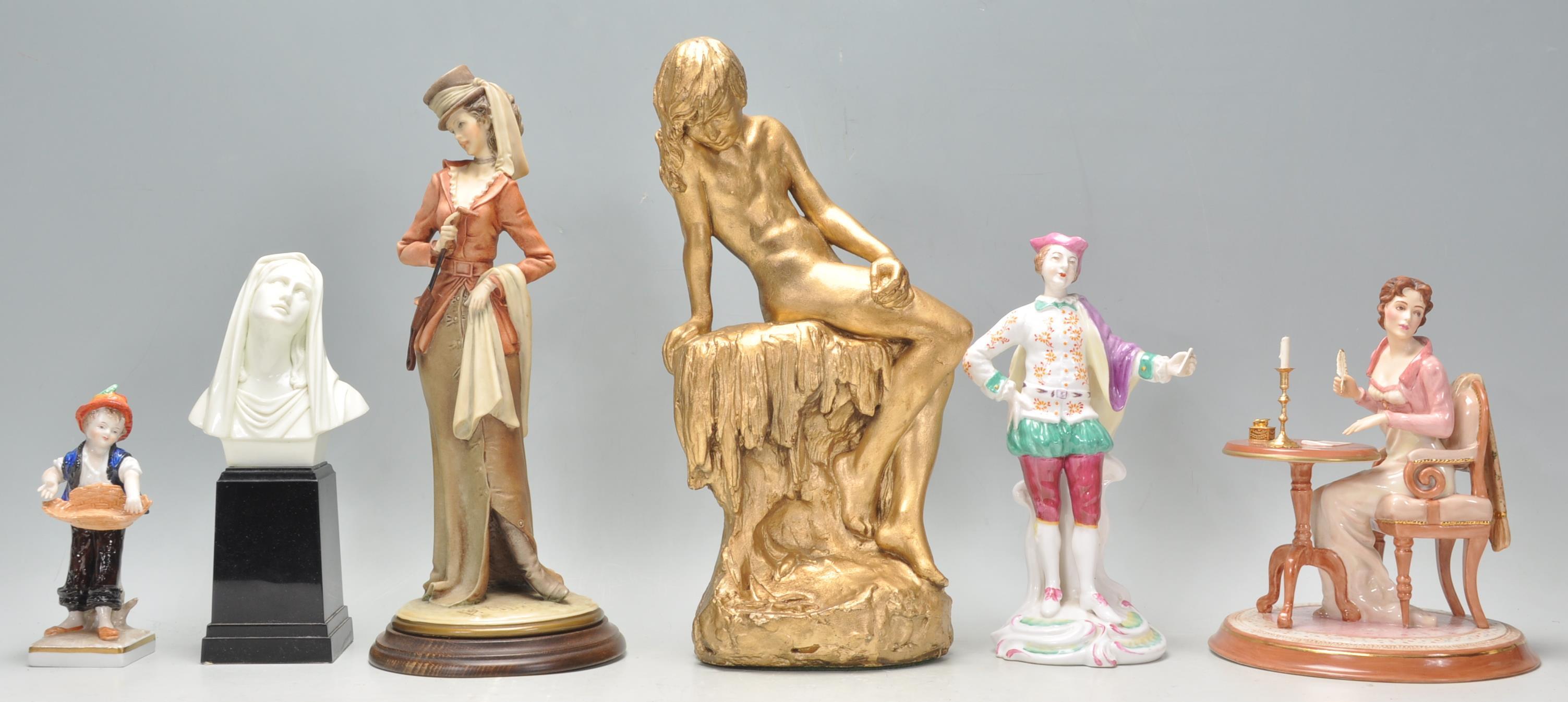 A group of 20th Century ceramic figurines to include a a Spode hand painted gentleman figurine, a