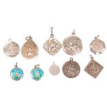A collection of ten silver St Christopher pendants of various forms including two enamelled