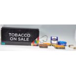 A mixed group of tobacco related items to include a 'Tobacco on sale' dispensing machine with