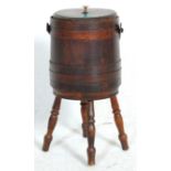 A 20th Century stained pine coopered wine cooler barrel / planter raised on turned supports with a