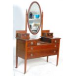 An Edwardian mahogany inlaid drop centre dressing table chest of drawers.  Raised on square tapering