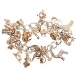 A good vintage English silver hallmarked charm bracelet adorned with many charms to include small