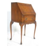 A vintage 20th century Queen Anne style walnut bureau desk having a fully appointed interior and red