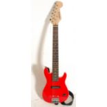 A C. Giants children's Fender Stratocaster style six string electric guitar having a red finished
